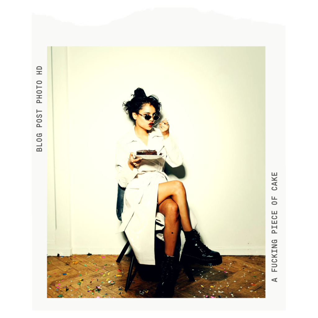 Old photo frame with modern picture of woman sitting on a chair in a white trench eating chocolate cake